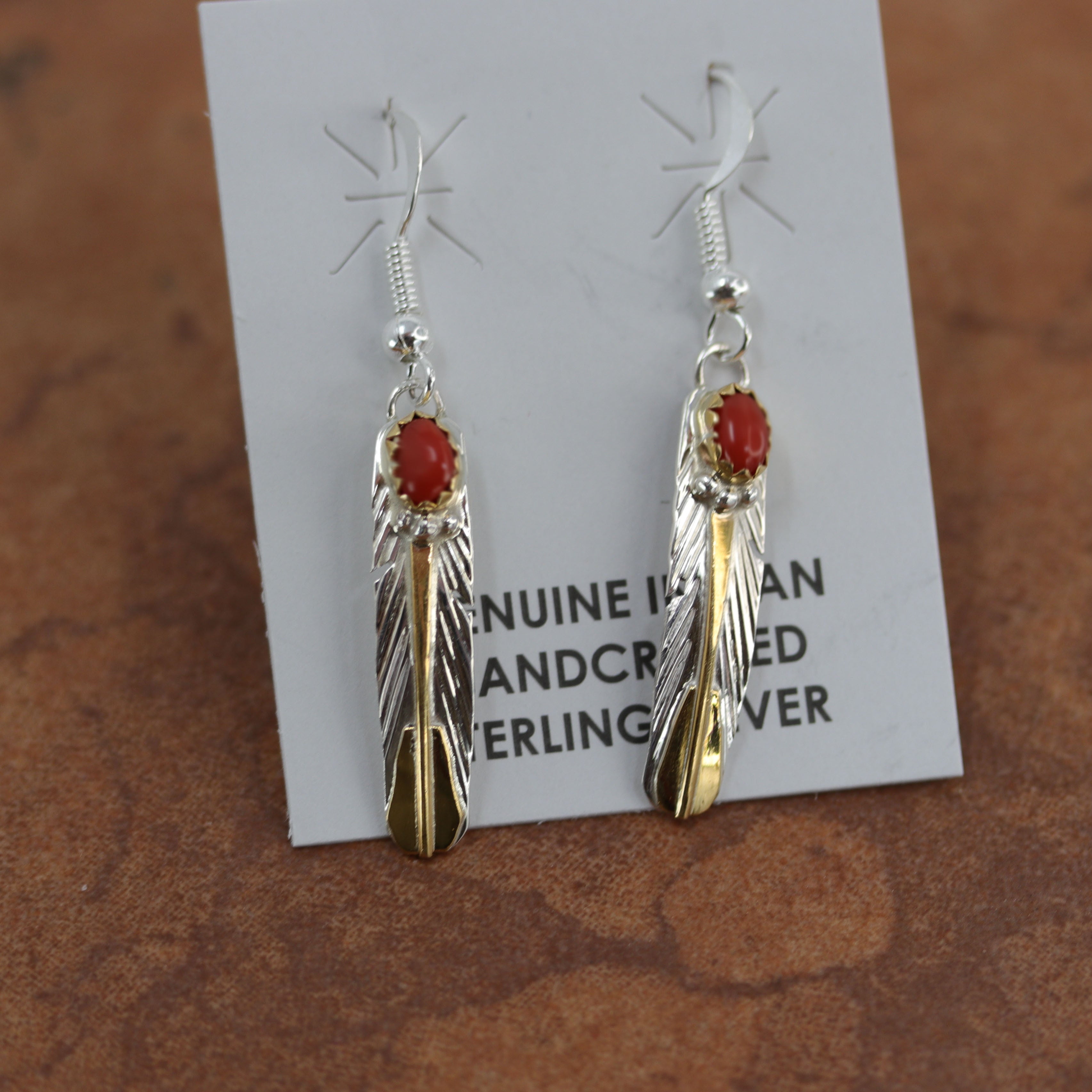 They are made from sterling silver and created opal. The earrings are about 1 7/8" in length including, and about 3/8" wide.