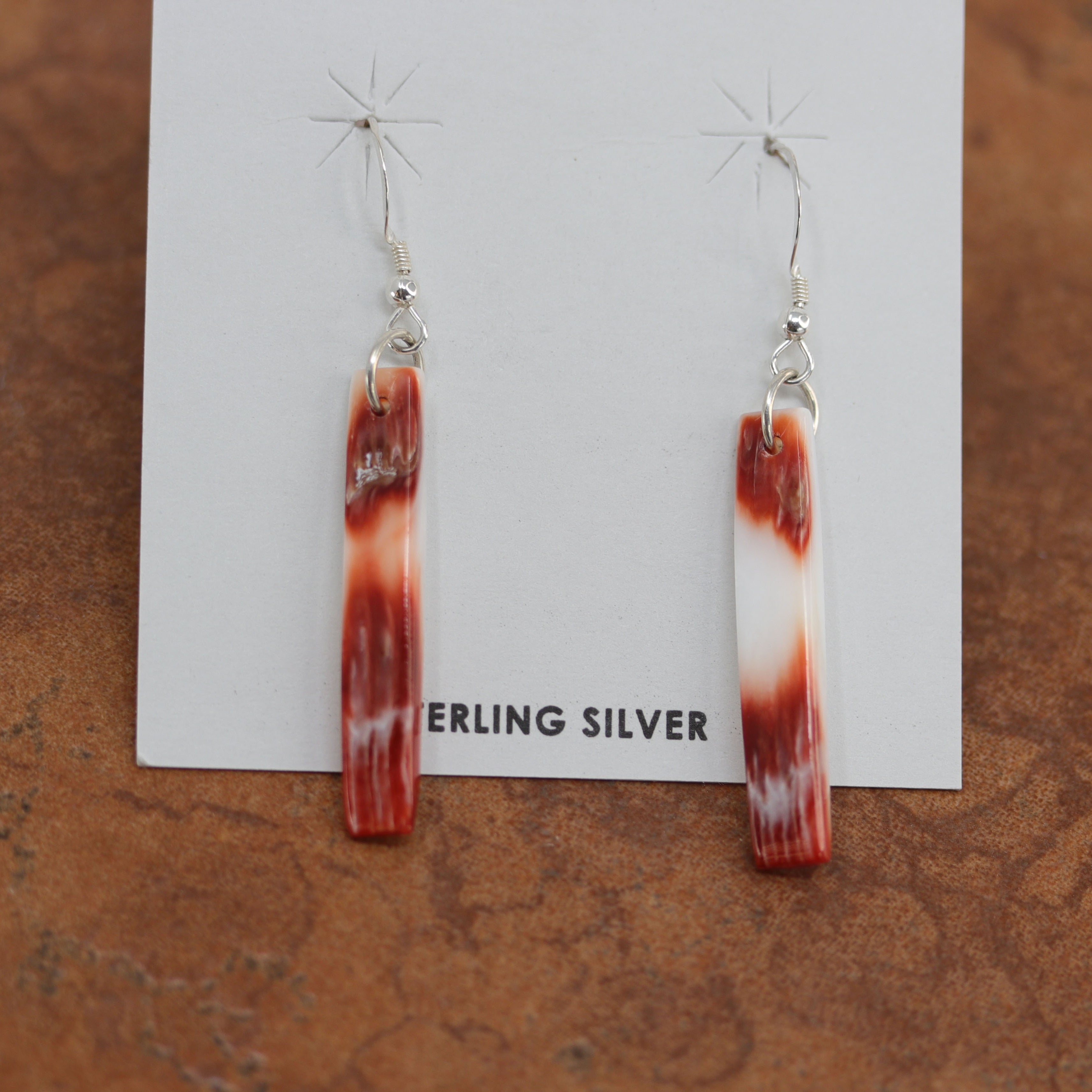 Gorgeous Navajo Native American earrings. They are made from sterling silver and spiny oyster. The earrings are about 2 1/8" in length, and 1/4" in width. 