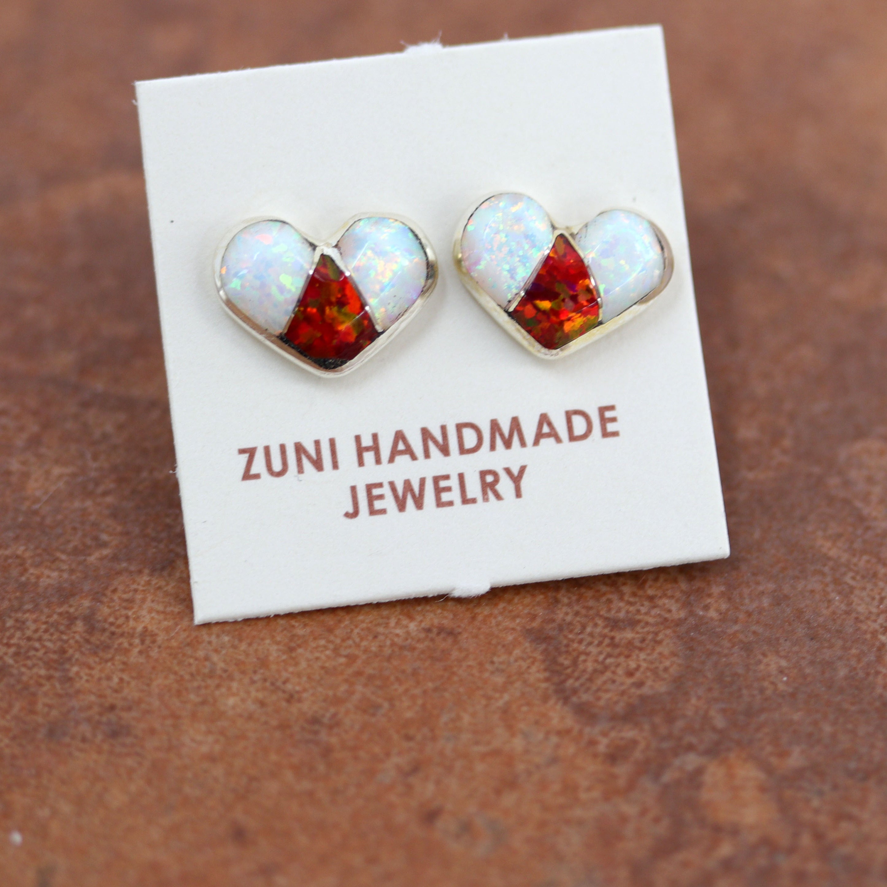 Beautiful Zuni Native American heart earrings. They are made from sterling silver and created opal. Each earring is 3/8" in length, and about 3/8" in width.