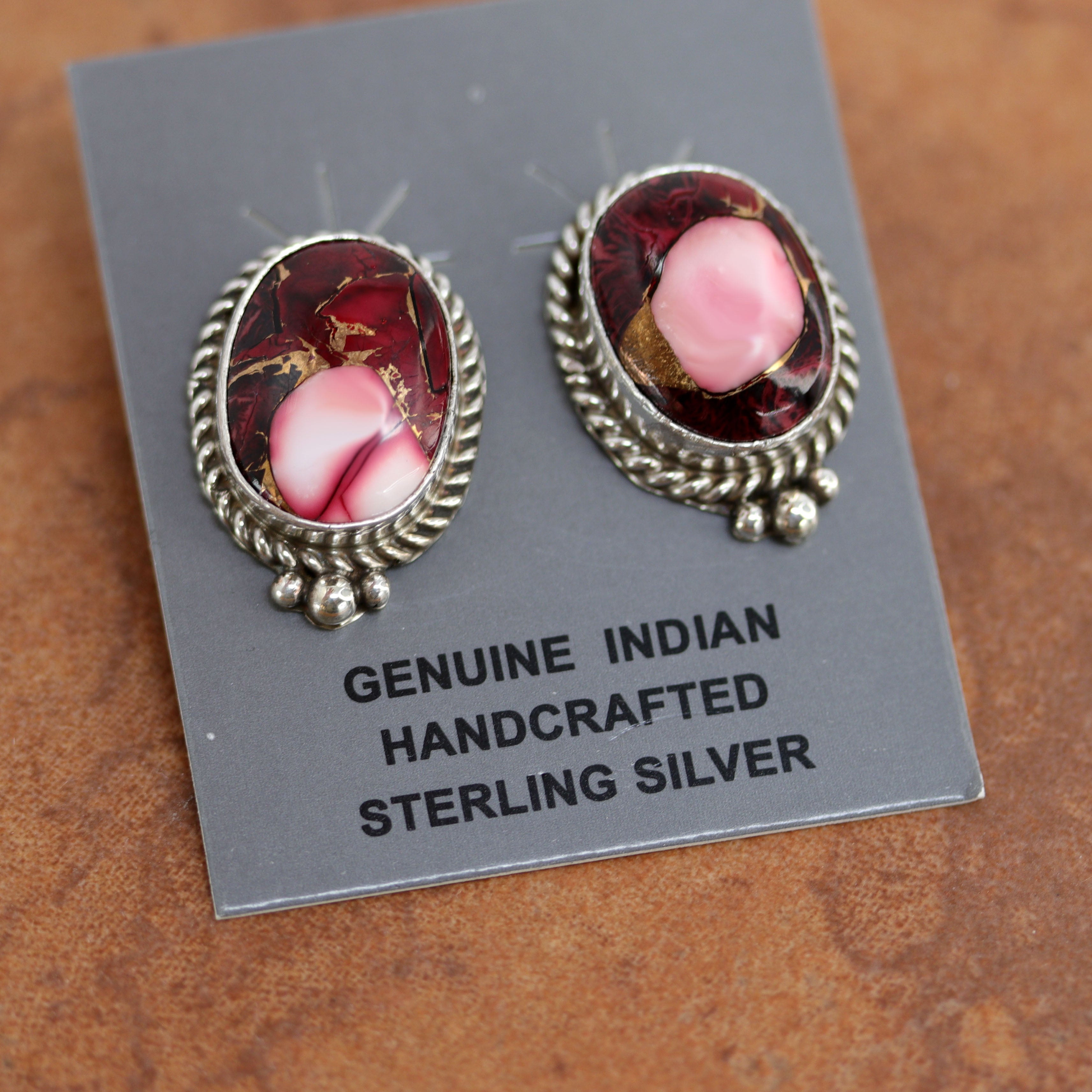 Navajo earrings. They are made from sterling silver and dahlia. Each earring is 1" in length and 3/4" in width. 