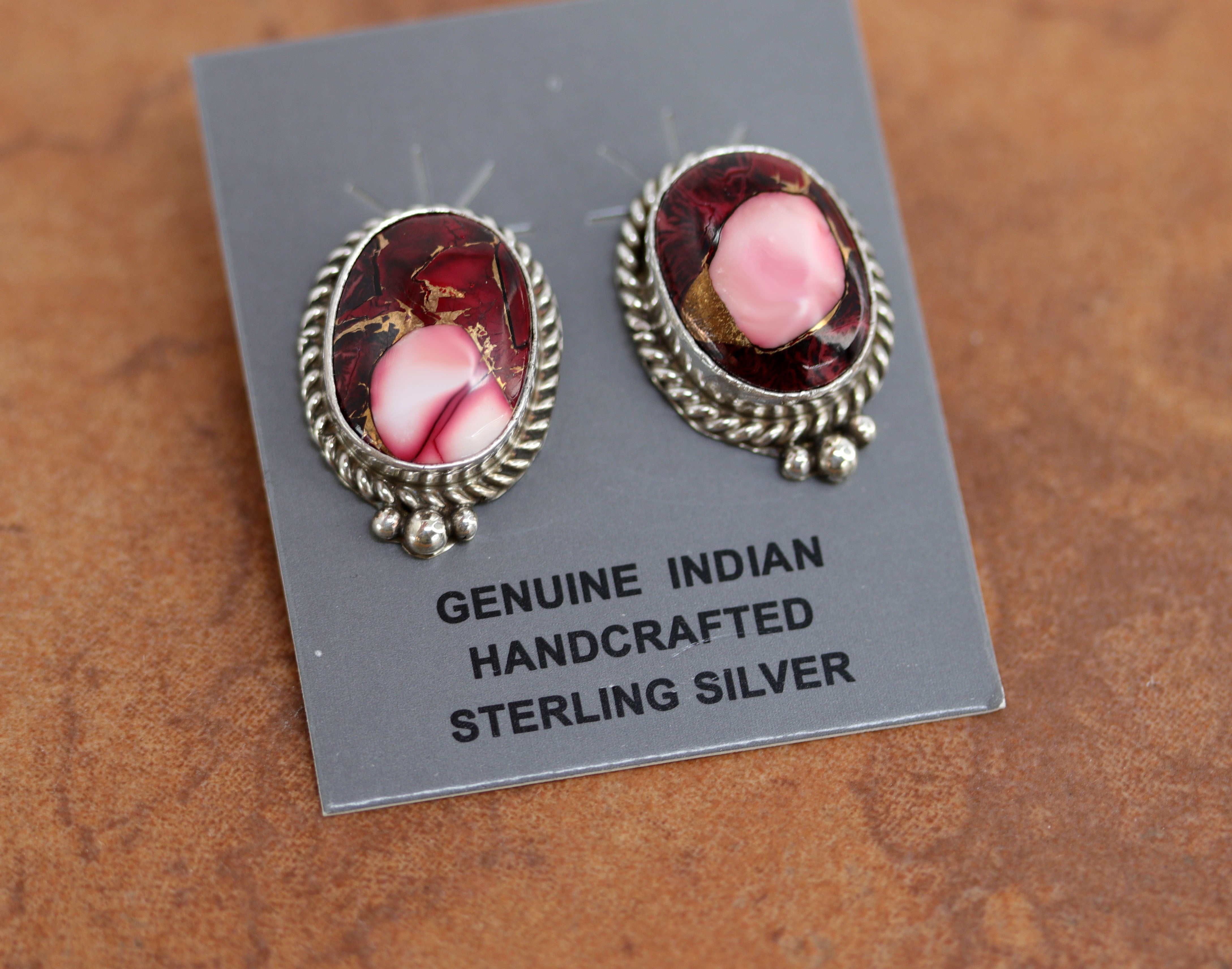 Navajo earrings. They are made from sterling silver and dahlia. Each earring is 1" in length and 3/4" in width. 