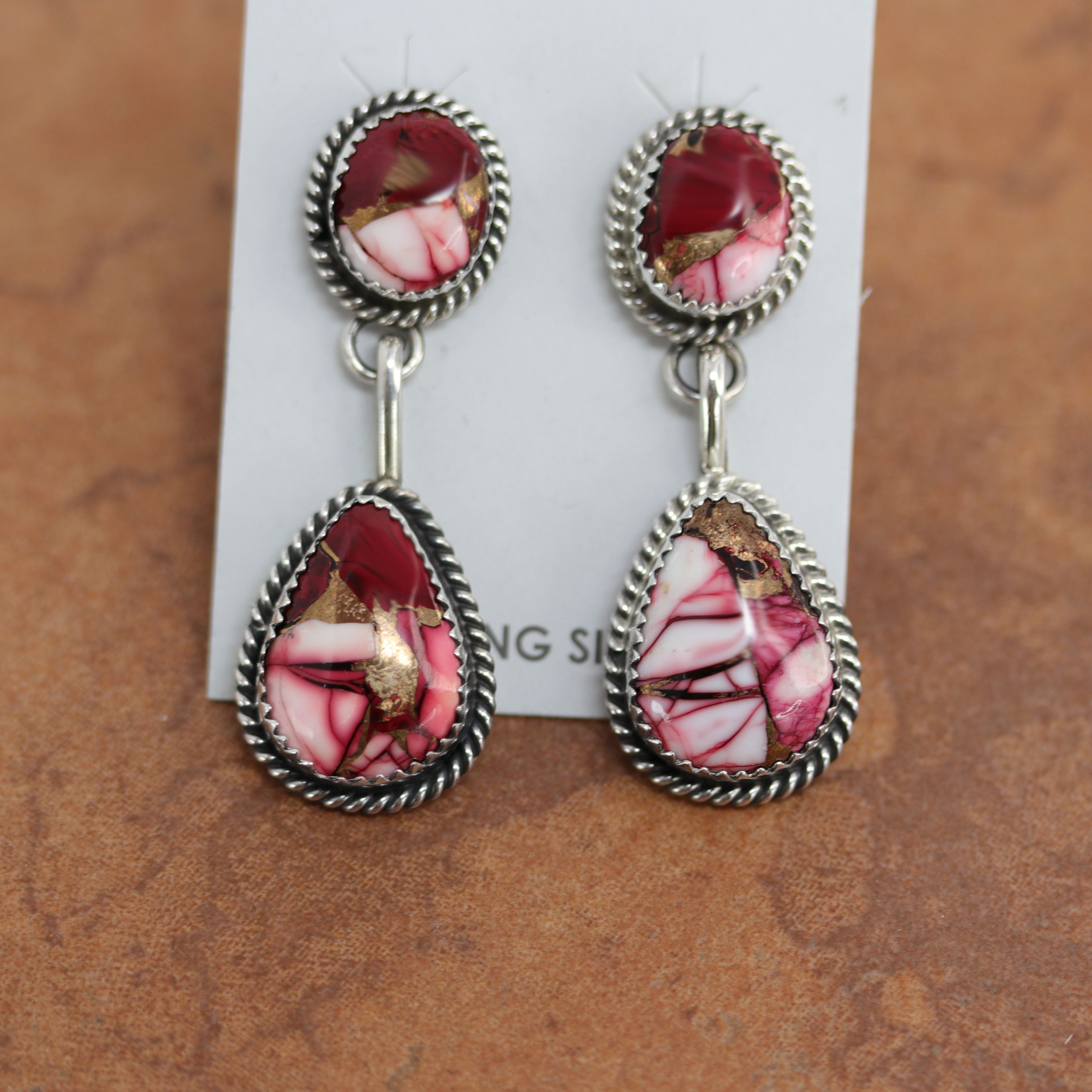Navajo earrings. They are made from sterling silver and dahlia. Each earring is 2" in length and 3/4" in width. 