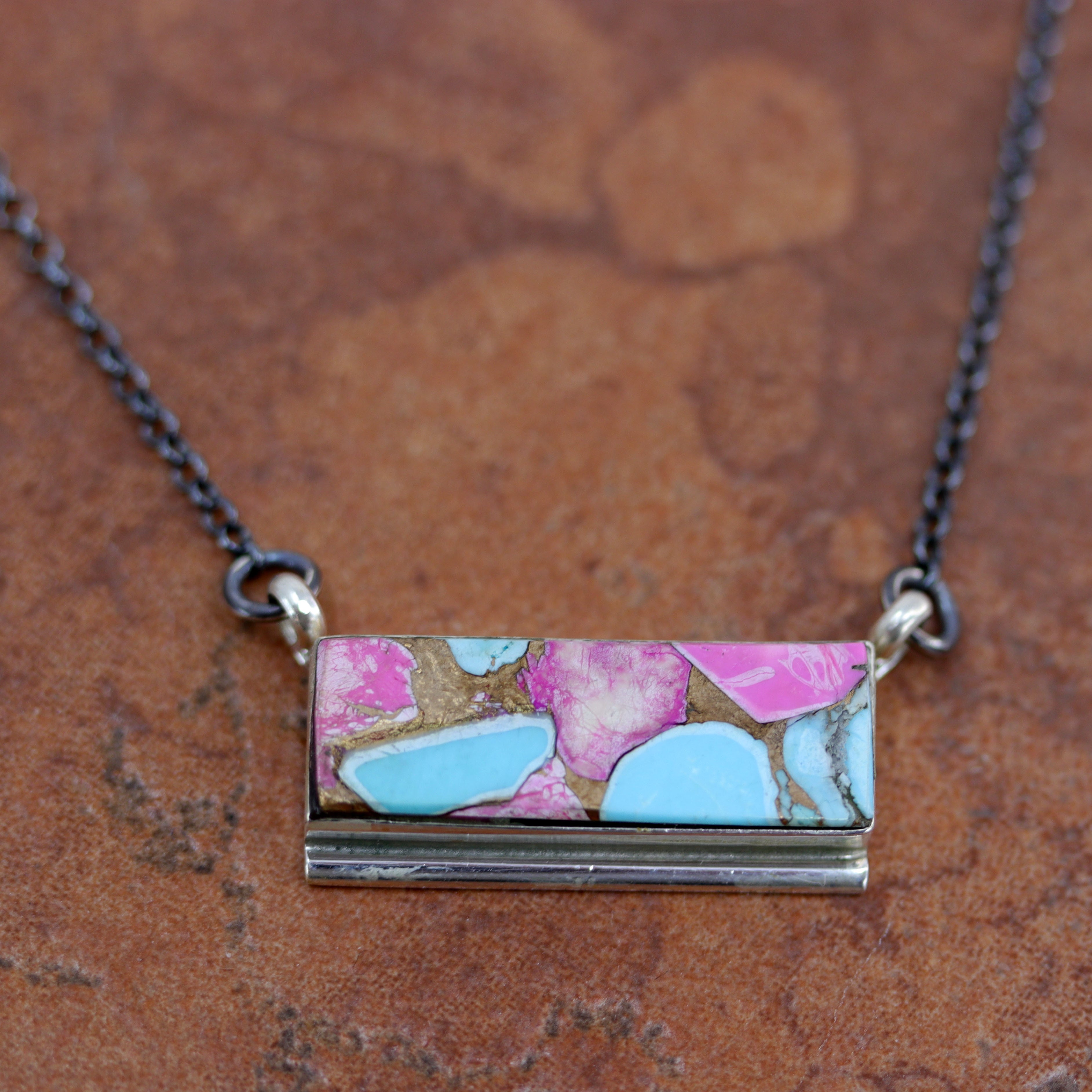 A beautiful Navajo Native American necklace. It is made from sterling silver, and cotton candy dahlia turquoise. The necklace is about 17" in length. The center pendant measures 1 1/8" by 5/8".