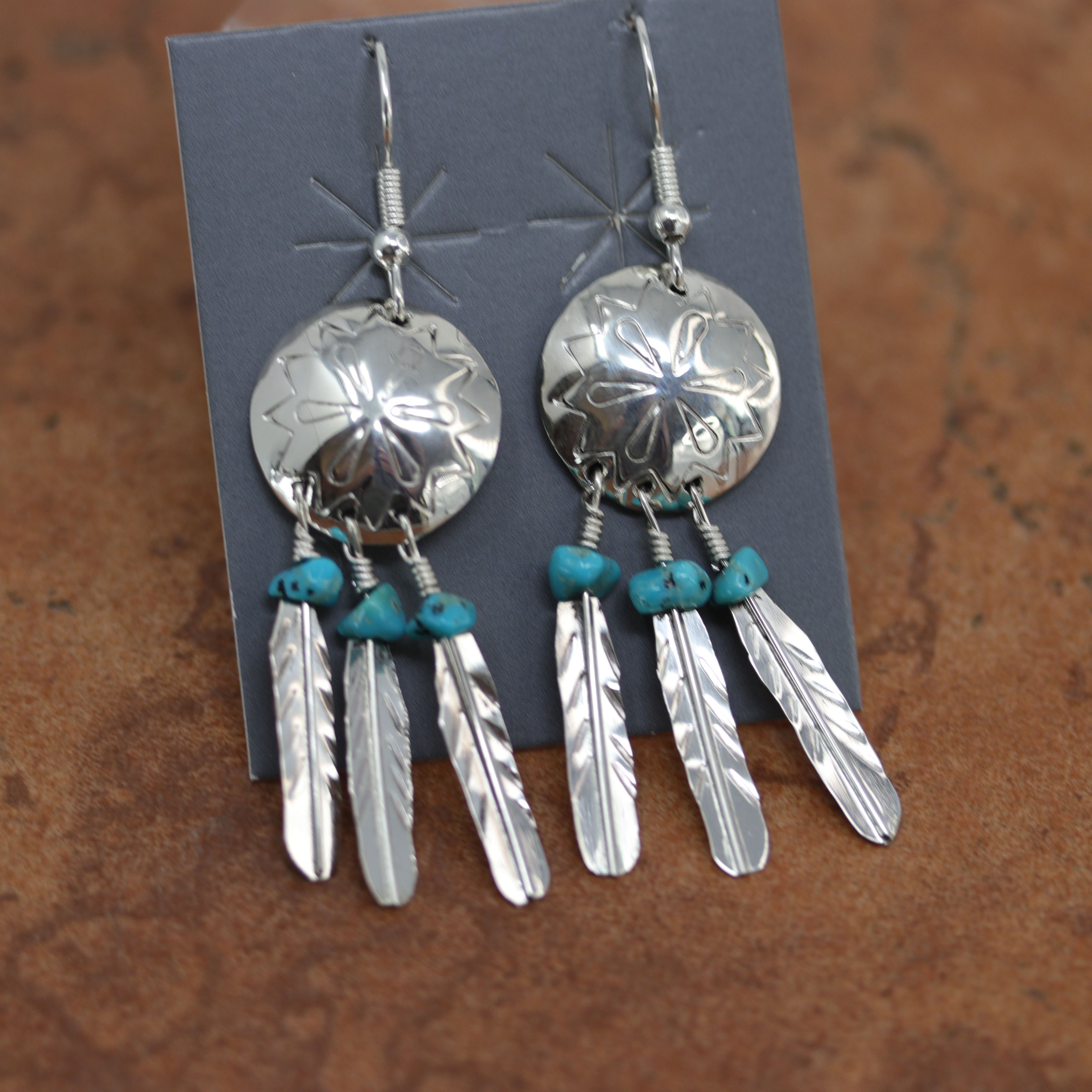 A beautiful Navajo Native American earrings. They are made from sterling silver and turquoise. The earrings are about 1" in length including the hook and 1/4" wide.