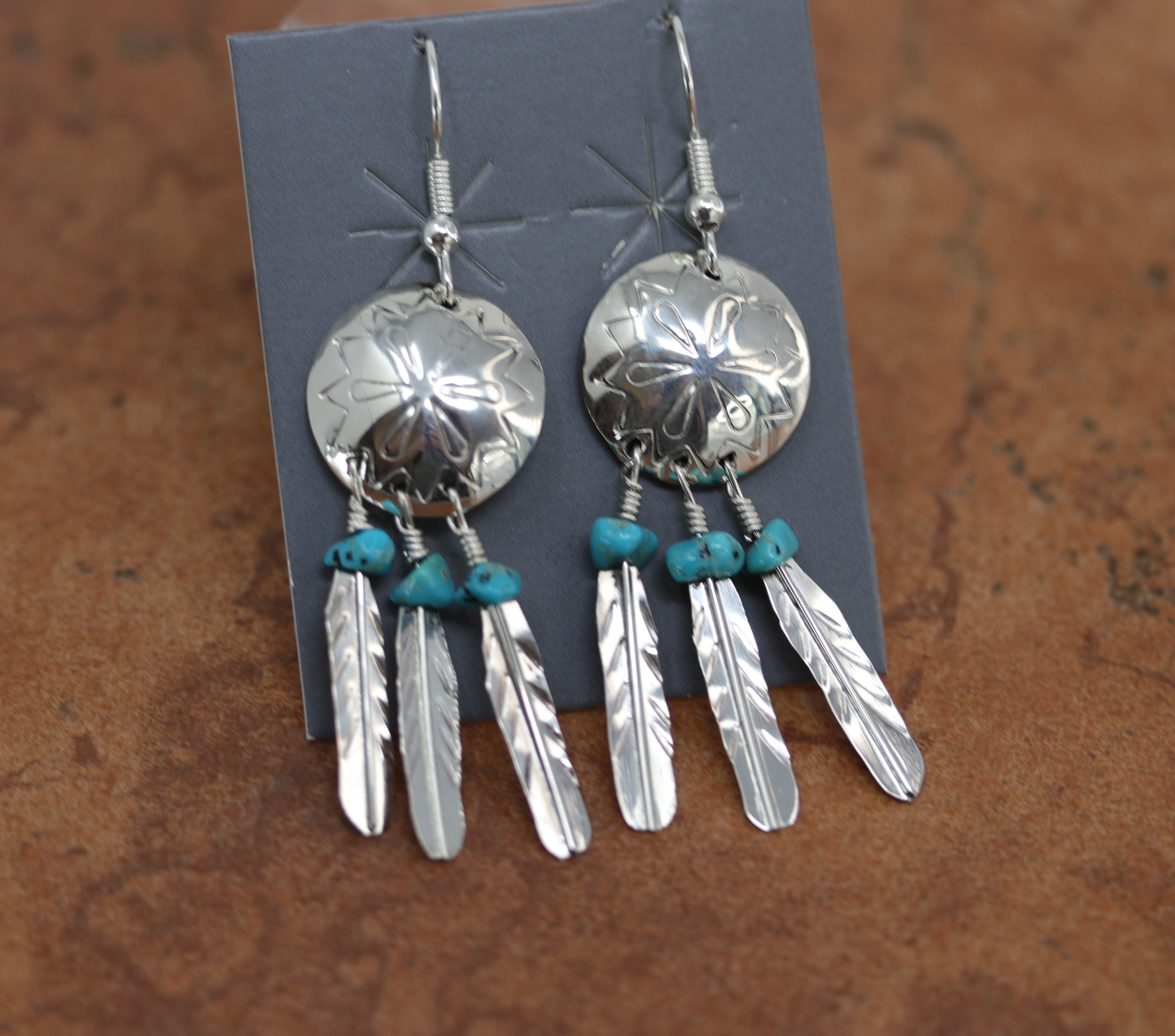 A beautiful Navajo Native American earrings. They are made from sterling silver and turquoise. The earrings are about 1" in length including the hook and 1/4" wide.