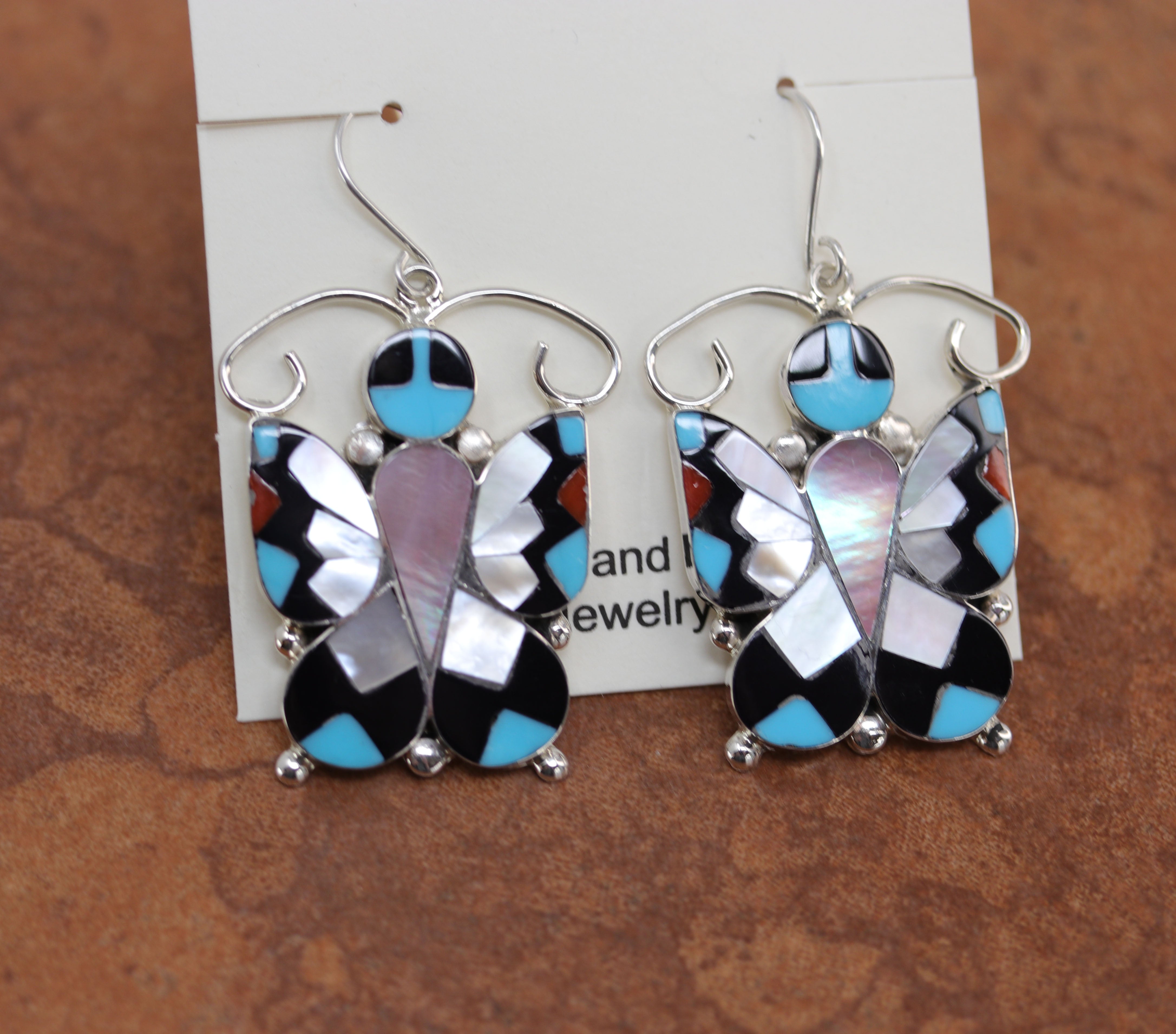 Authentic Zuni Native American earrings by A Dishta. They are made from sterling silver and multi-stone inlay. The earrings are 2 1/8" in length including the hook and 1 3/8" in width.