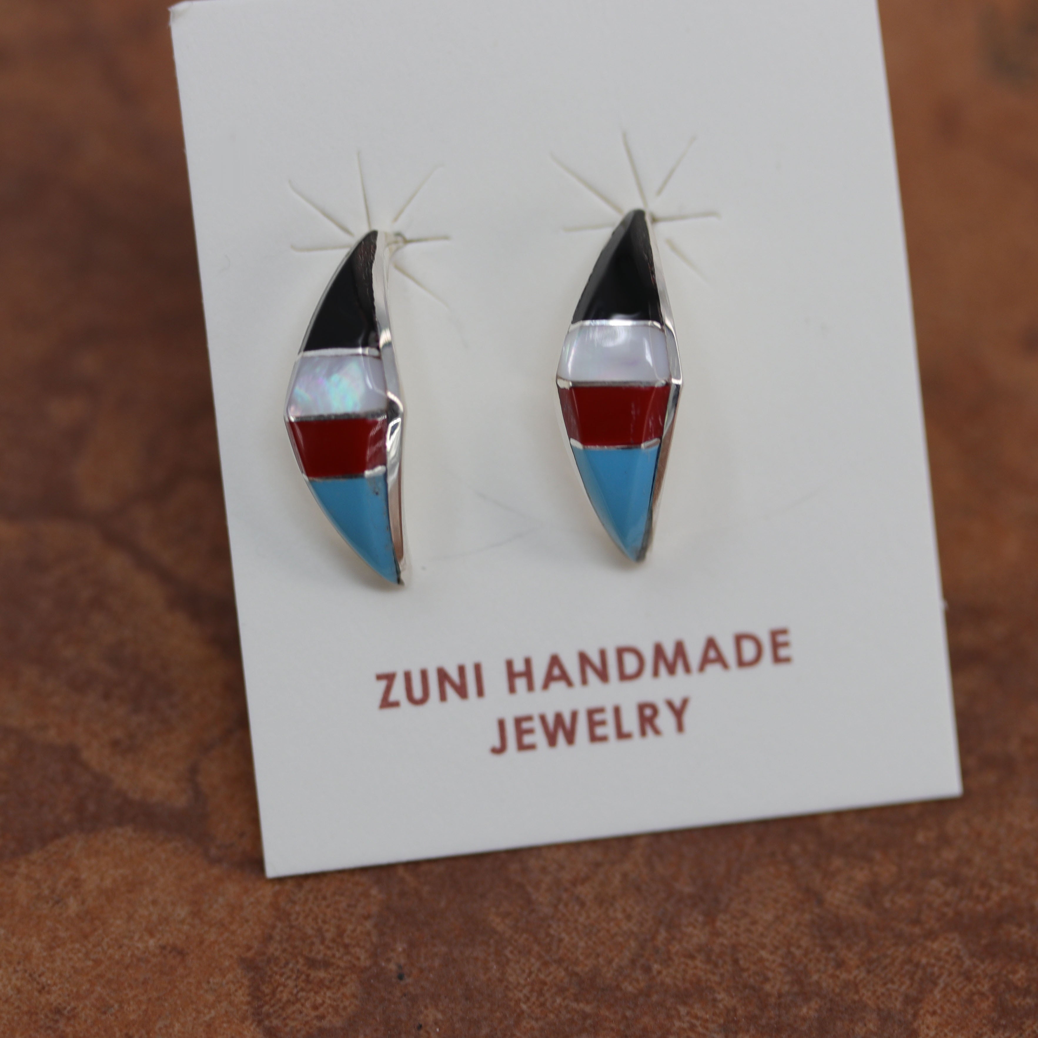 Beautiful Zuni Native American earrings by R Kanesta. They are made from sterling silver and multi-stone inlay. Each earring is 1" in length, and about 5/16" in width.