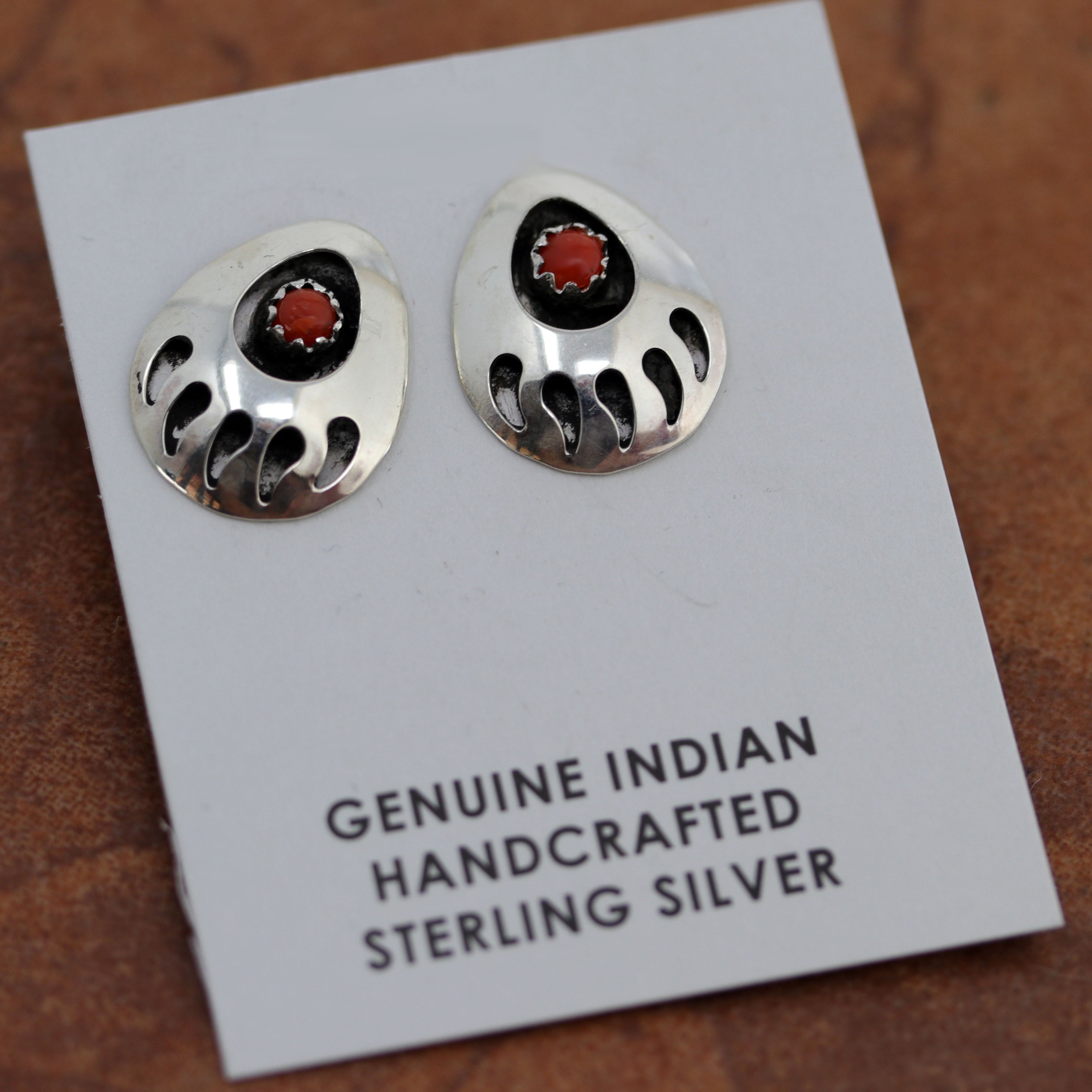 Native American earrings. They are made from sterling silver and coral. The earrings are about 3/4" in length and 1/2" wide.
