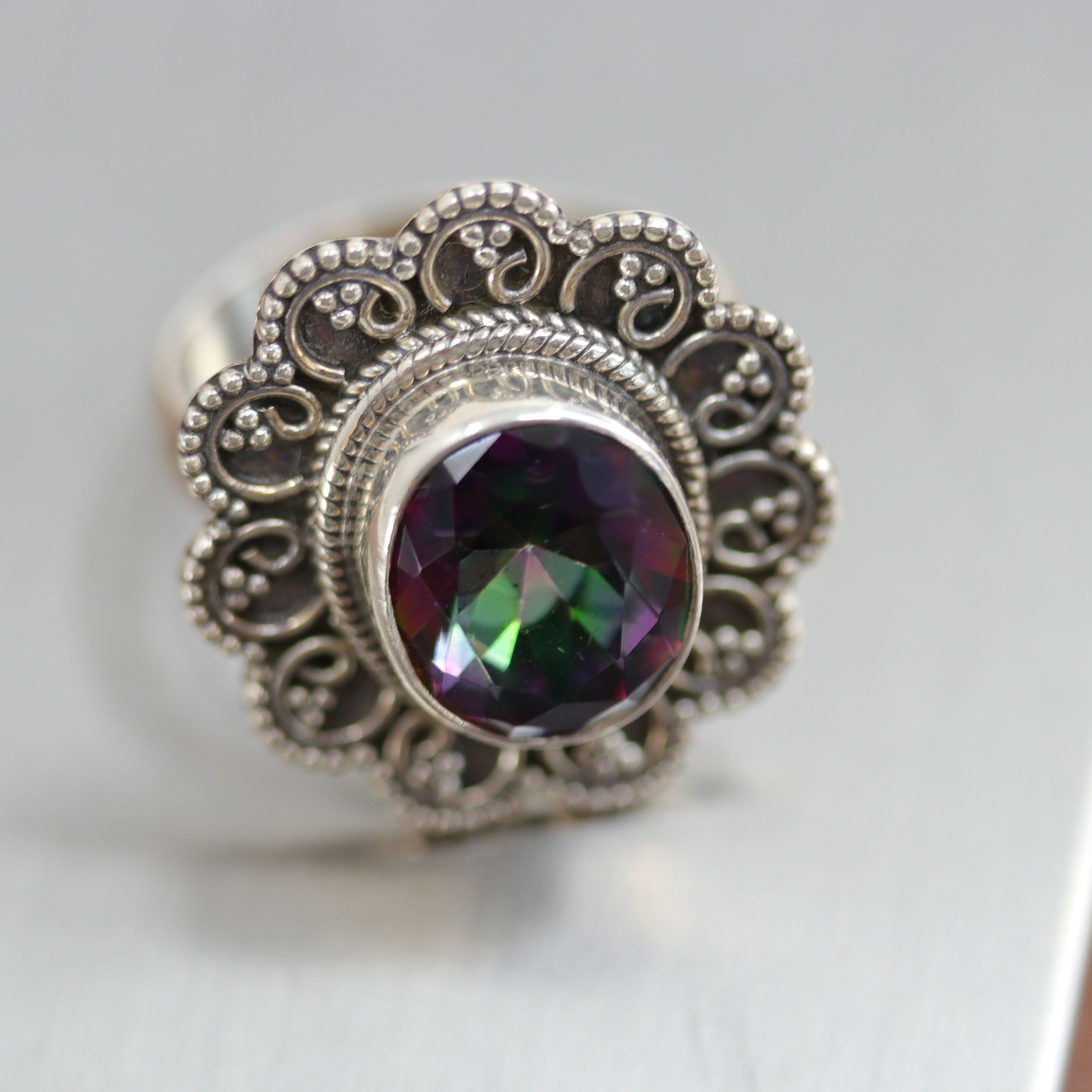 A beautiful Southwest Style gemstone ring made from sterling silver and mystic topaz. The ring size is 6 1/2 and it is about 1 1/8" in length.