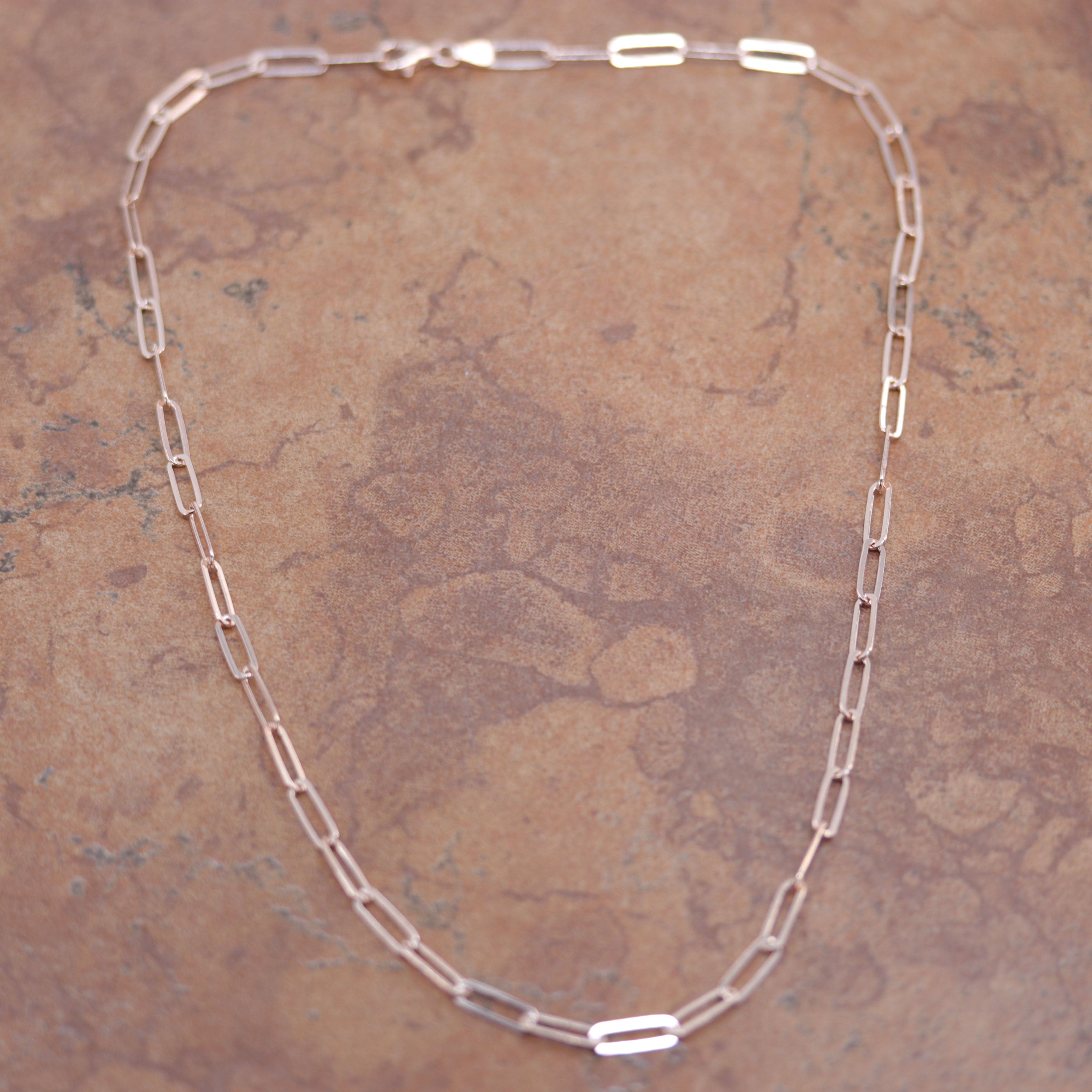 A Beautiful Paper Clip Chain Link Necklace. It is made from .925 sterling silver and rose gold overlay. The length is about 18" and the width is 3/16".