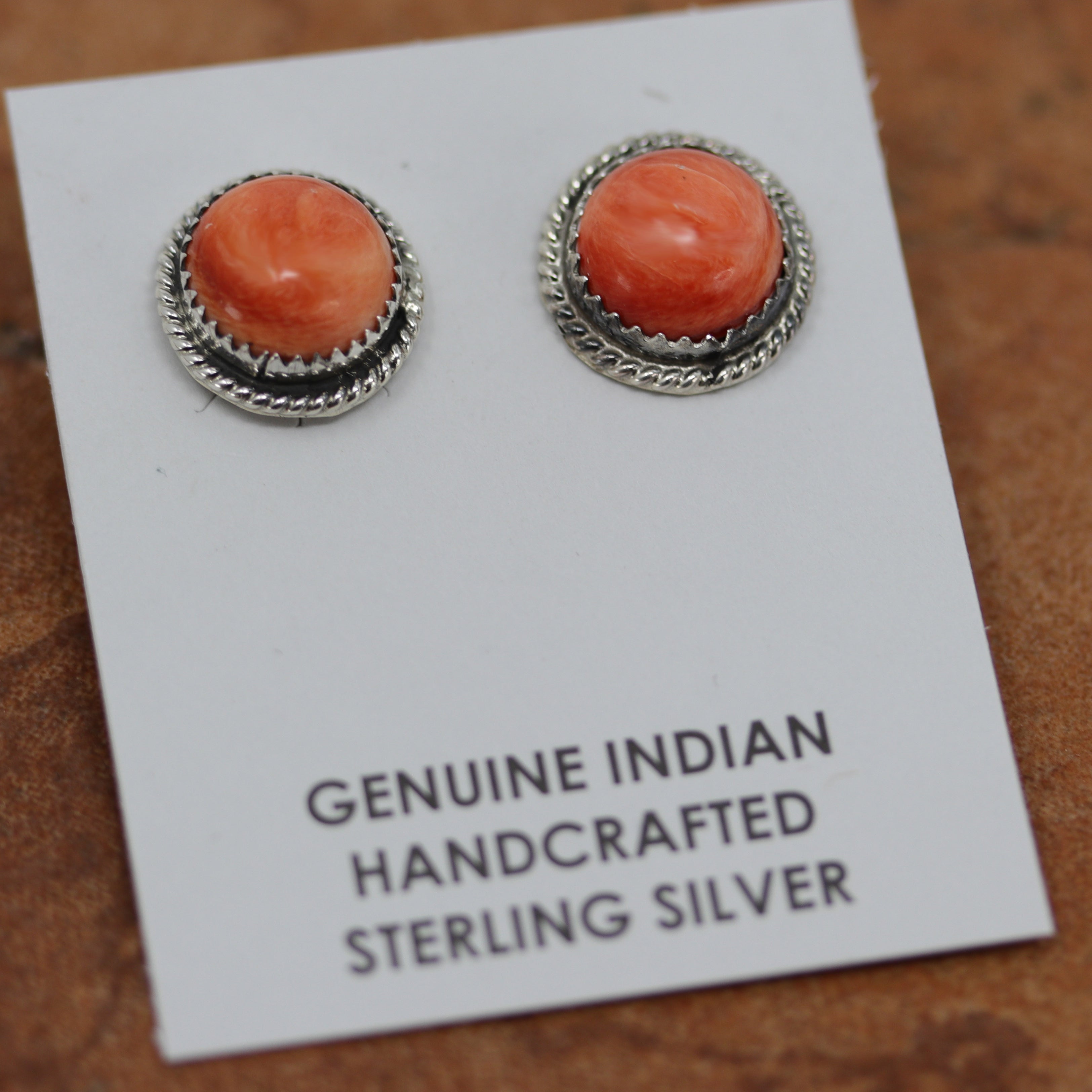 Beautiful Navajo Native American earrings. They are made from sterling silver and spiny oyster. The earrings are about 1/2" in diameter.
