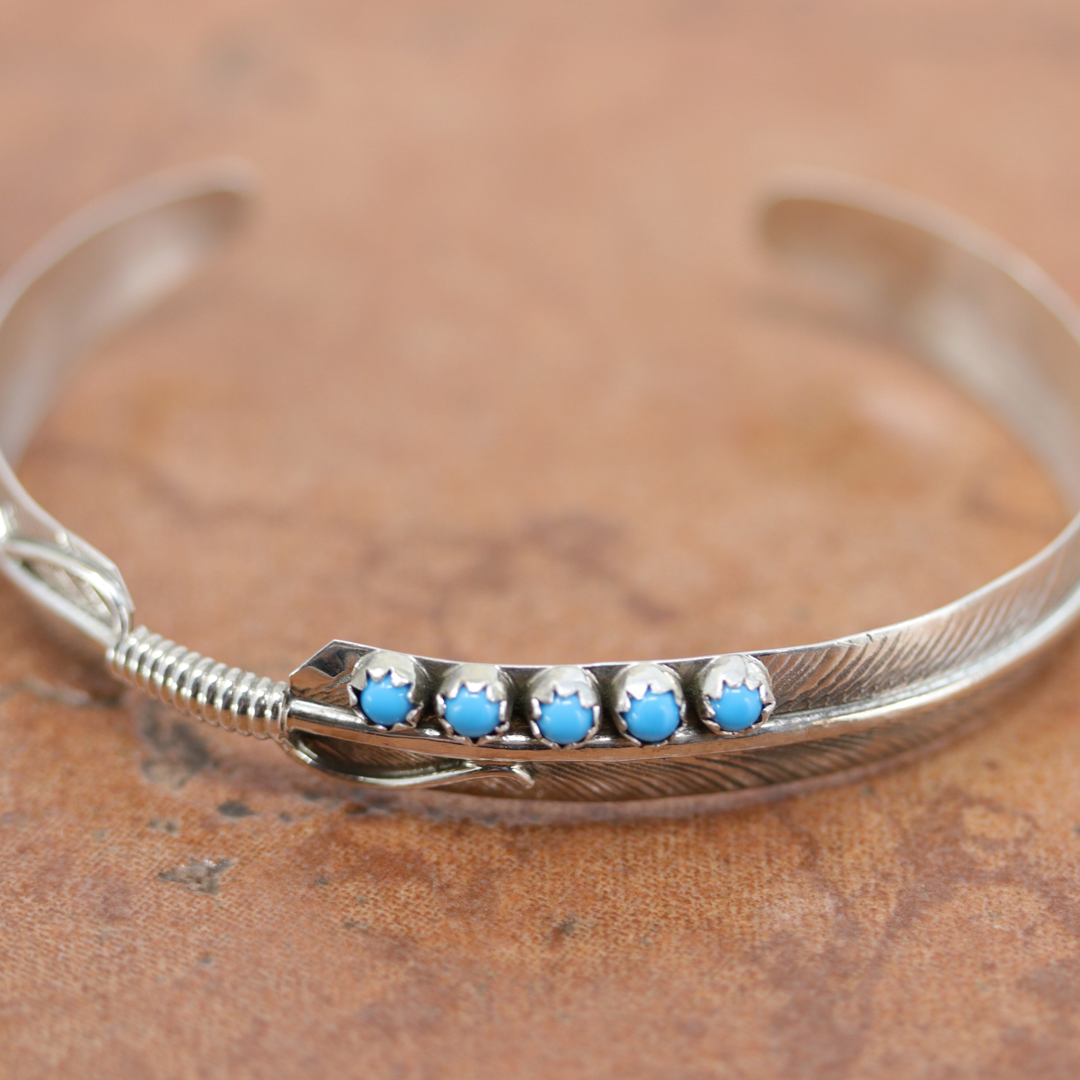 Navajo Native American bracelet. It is made from sterling silver and turquoise. It is about 5 1/4" around and about 3/8". The opening is about 1" and partly flexible.