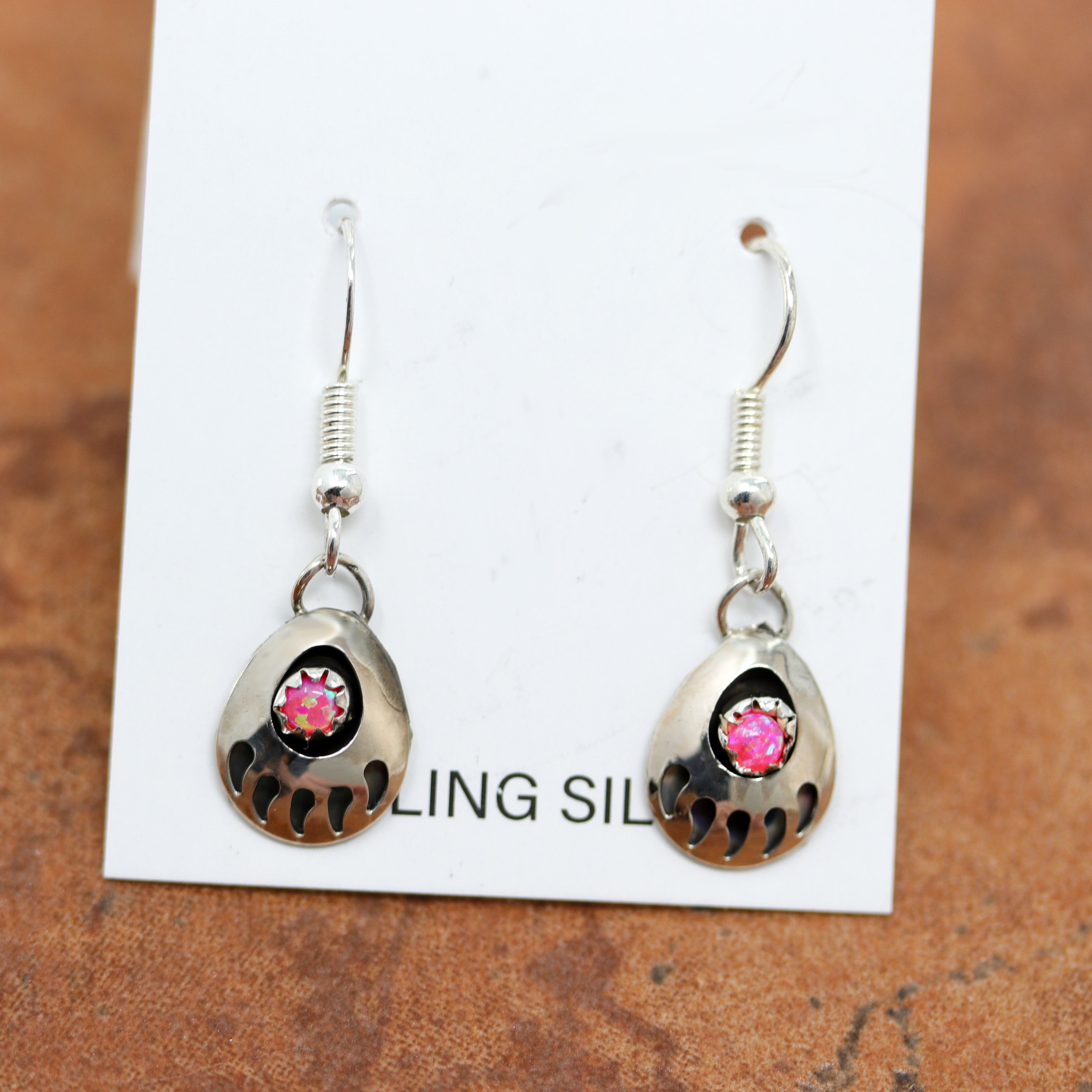 Beautiful Navajo Native American earrings made from sterling silver and pink created opal. The earrings are about 1 1/4" in length including the hook and 1/2" wide.