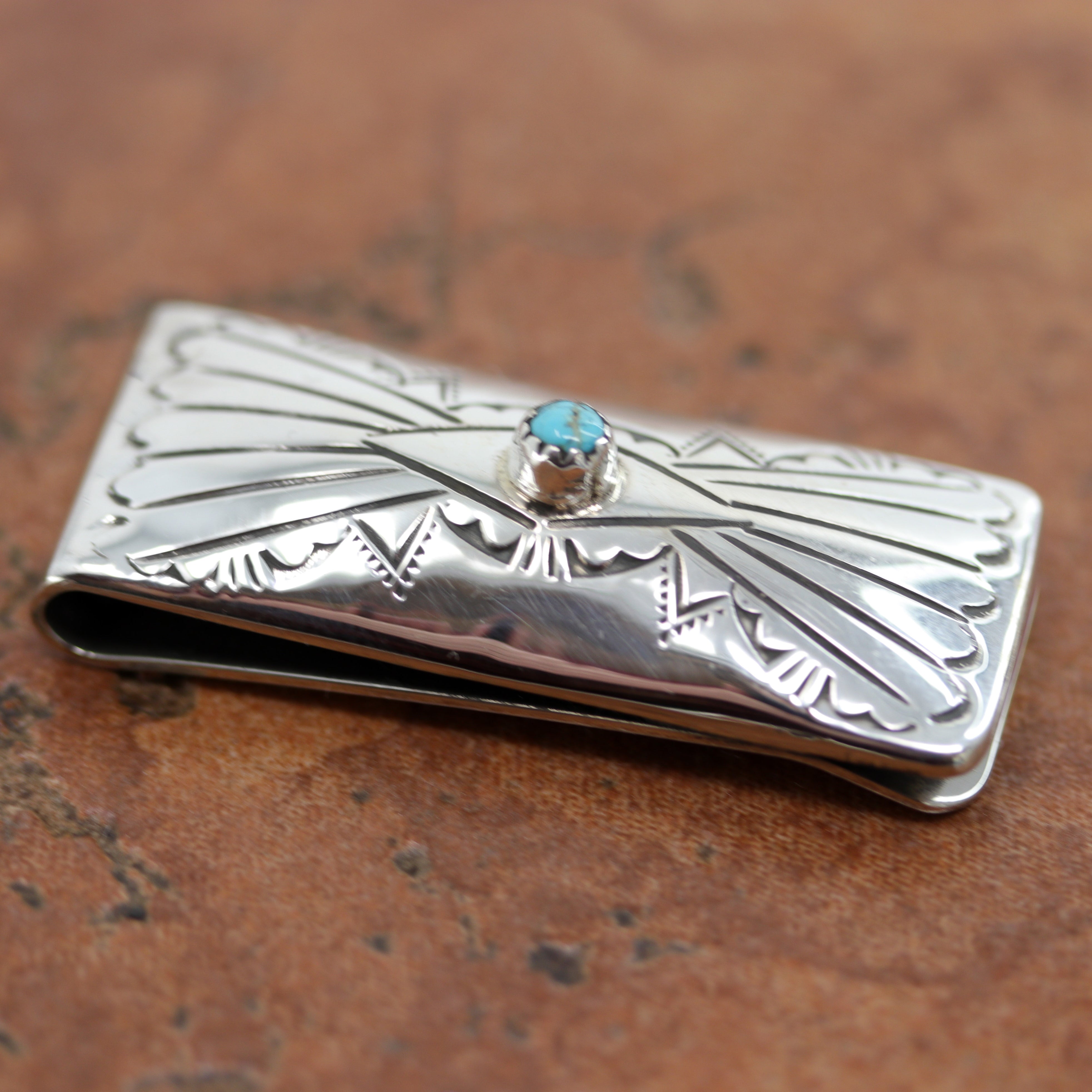 A brand new, very nice, authentic Native American money clip. It is made from sterling silver and turquoise. The lower part of the money clip is made from nickel to give it more durability. It is about 1 7/8" in length and 3/4" wide.