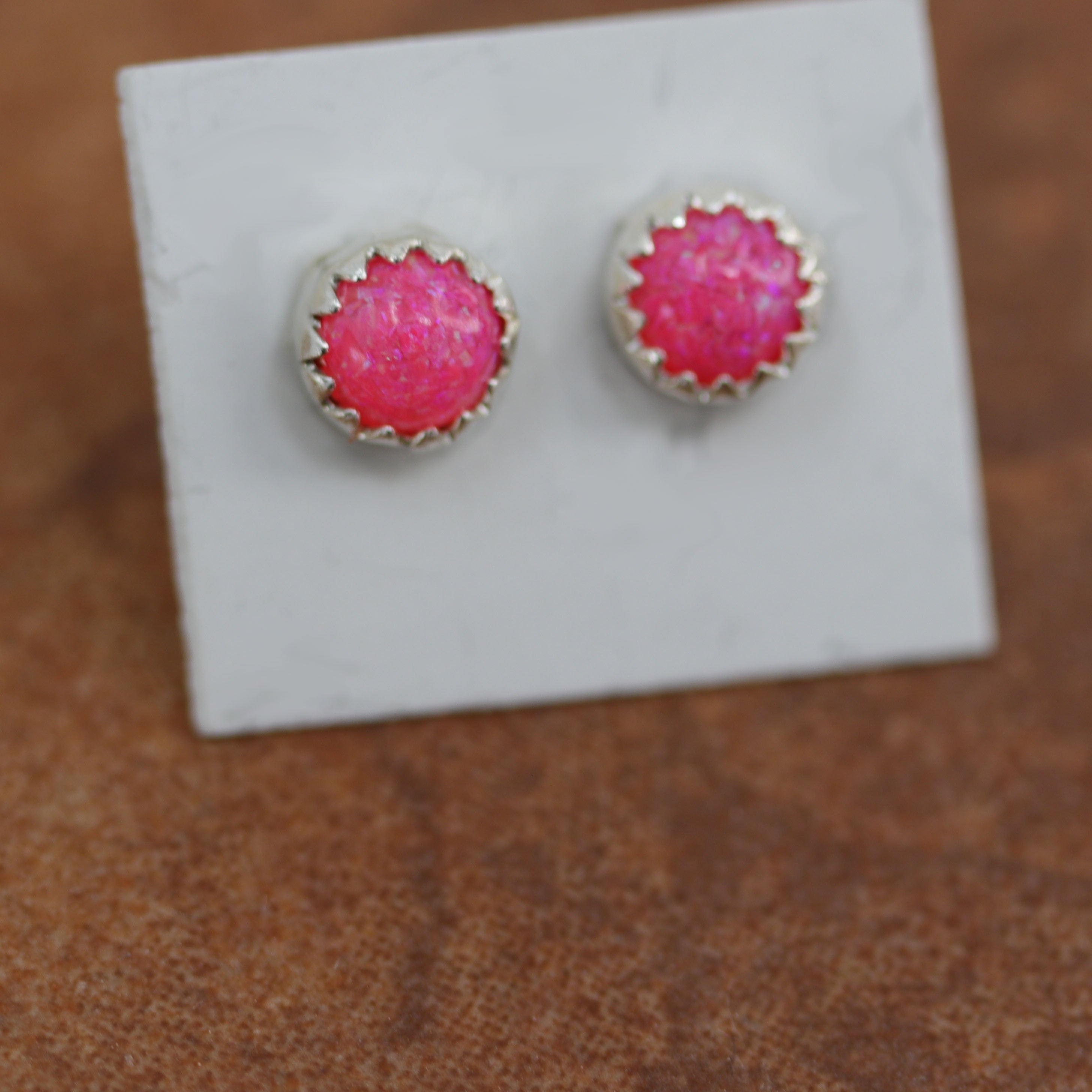 Brand new, very nice sterling silver earrings. They are made from sterling silver and created opal. The earrings are about 5/16" in diameter.