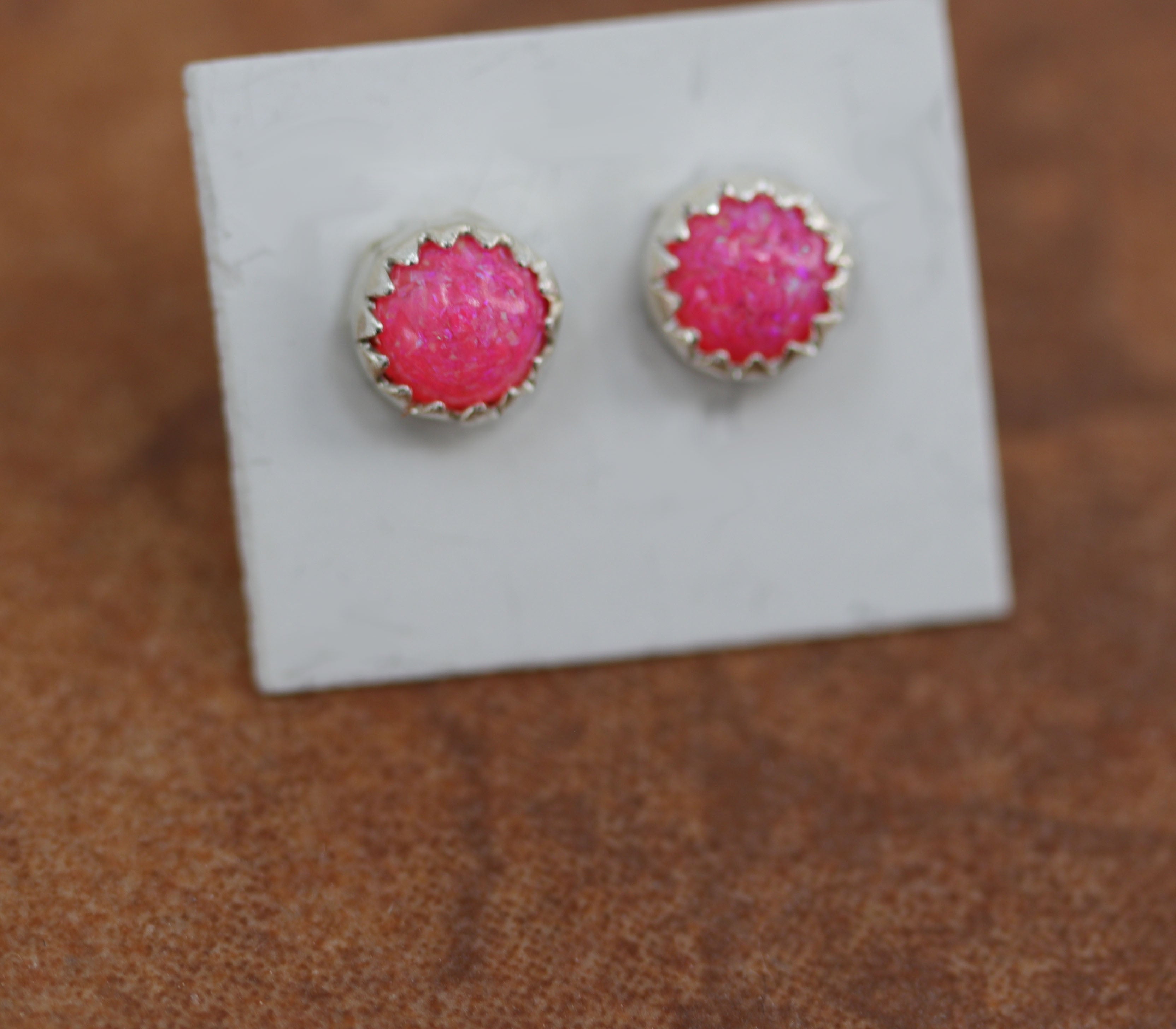 Brand new, very nice sterling silver earrings. They are made from sterling silver and created opal. The earrings are about 5/16" in diameter.