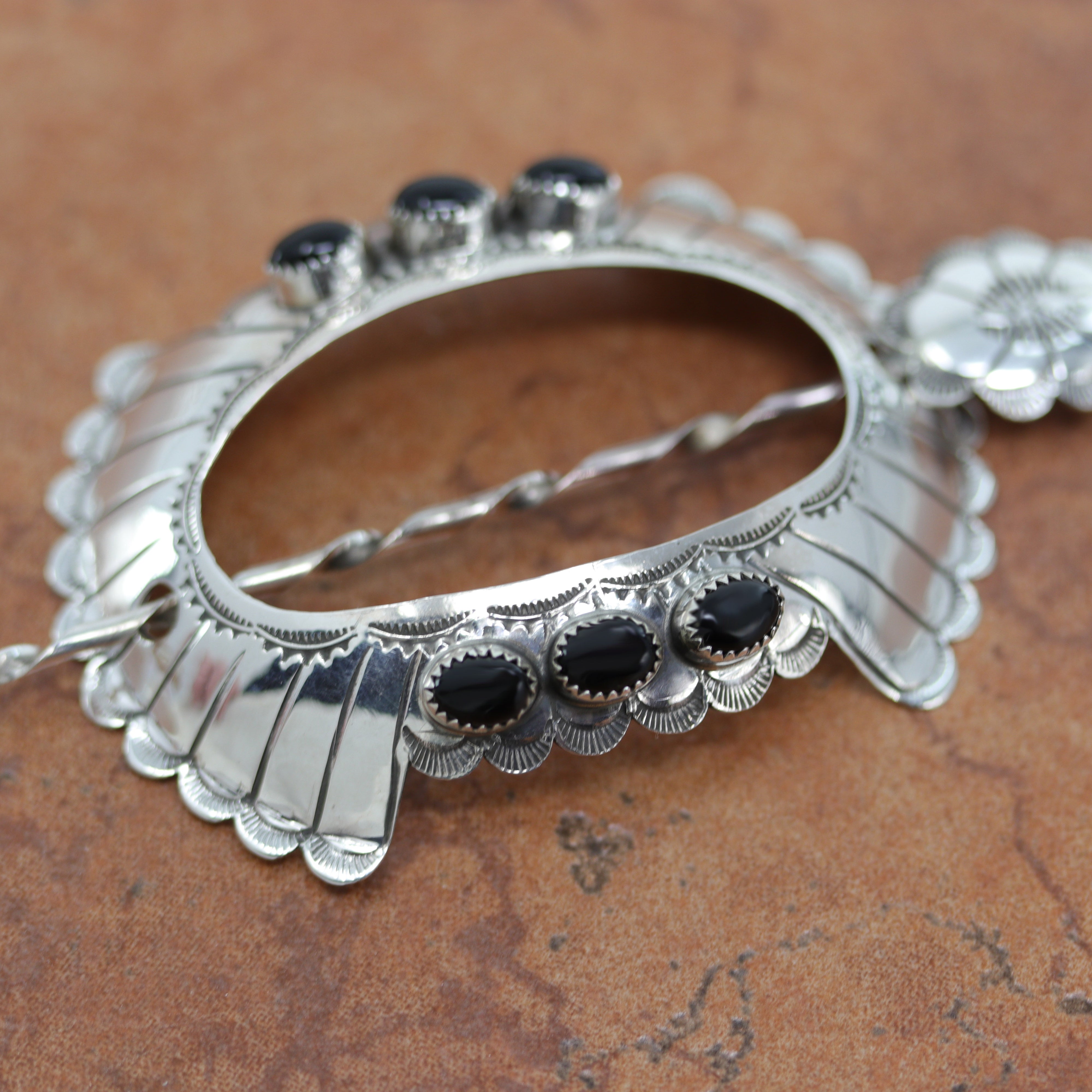 Navajo Native American Barrette made from sterling silver and onyx. It is 3" long, and about 2 1/8" wide. The pin measures 3 7/8" in length. 