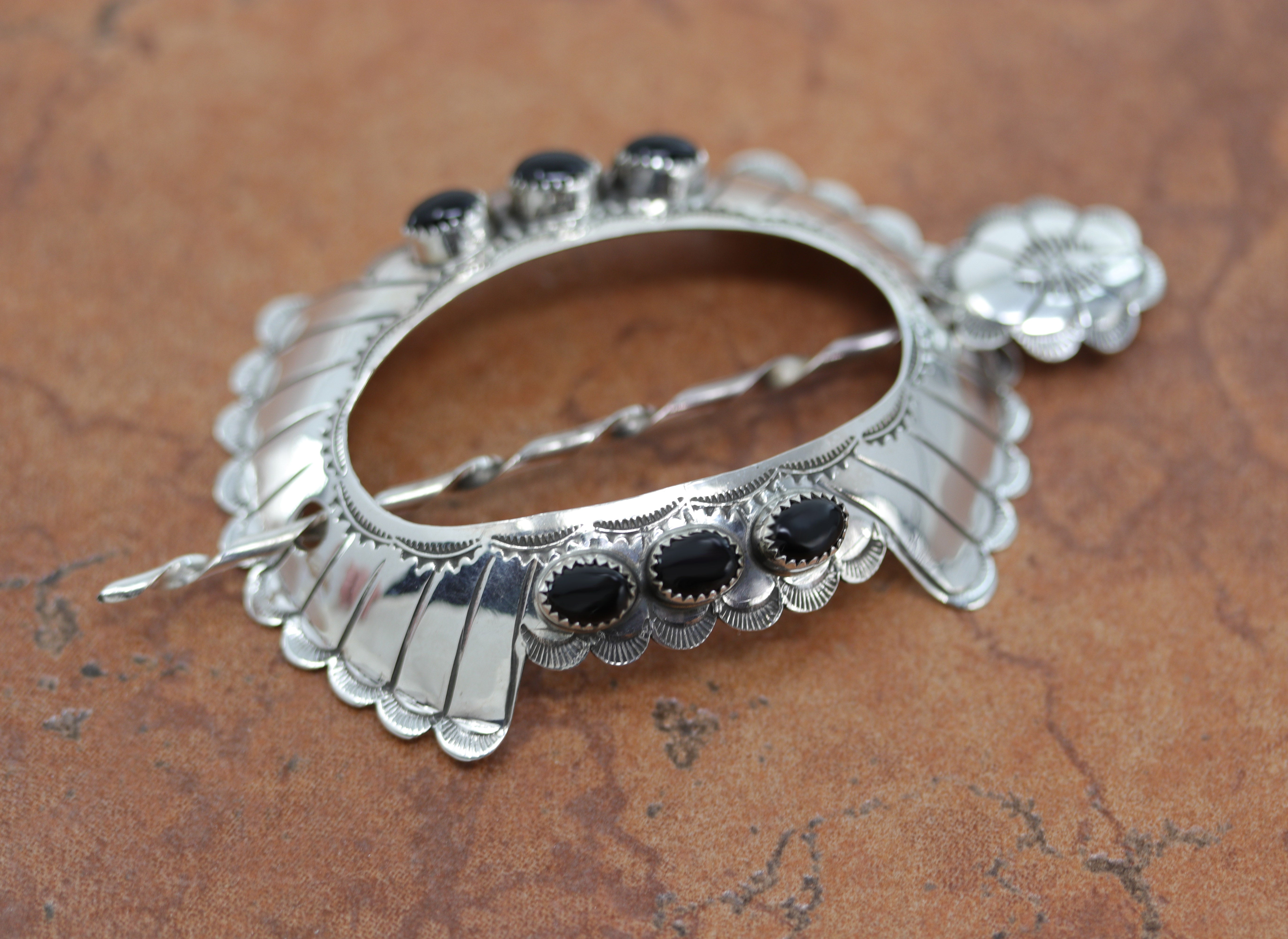 Navajo Native American Barrette made from sterling silver and onyx. It is 3" long, and about 2 1/8" wide. The pin measures 3 7/8" in length. 