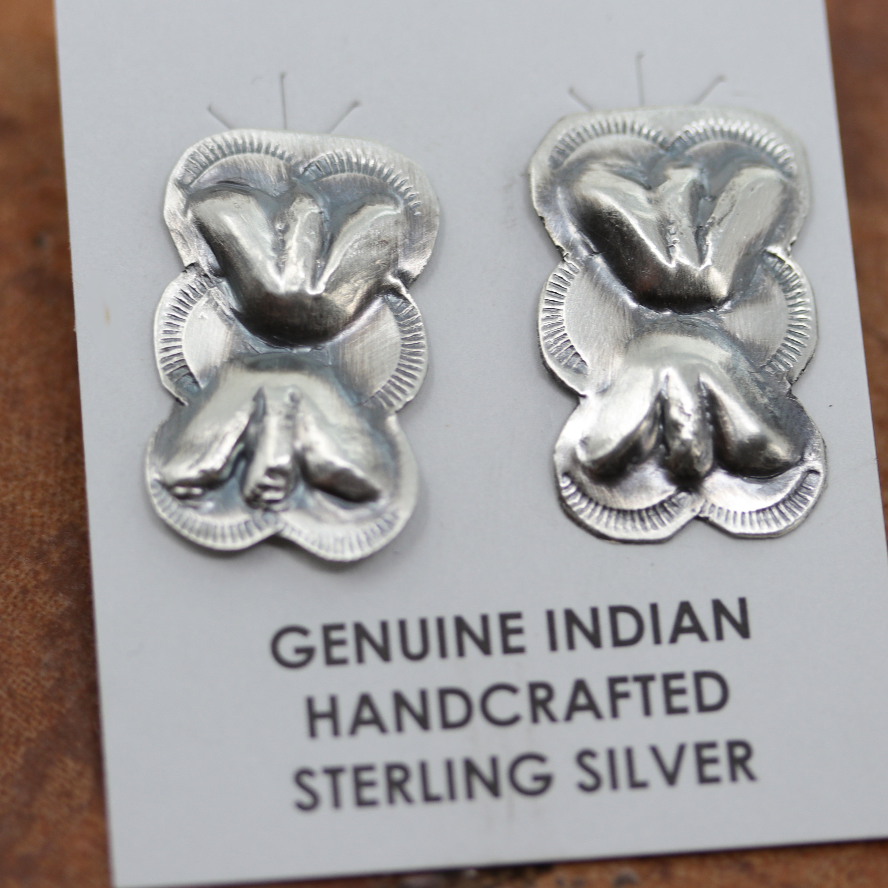 Navajo Native American earrings by Gabrielle Yazzie. They are made from sterling silver and turquoise. The earrings are 2 1/2" in length including the hook and 1 3/8" in width.