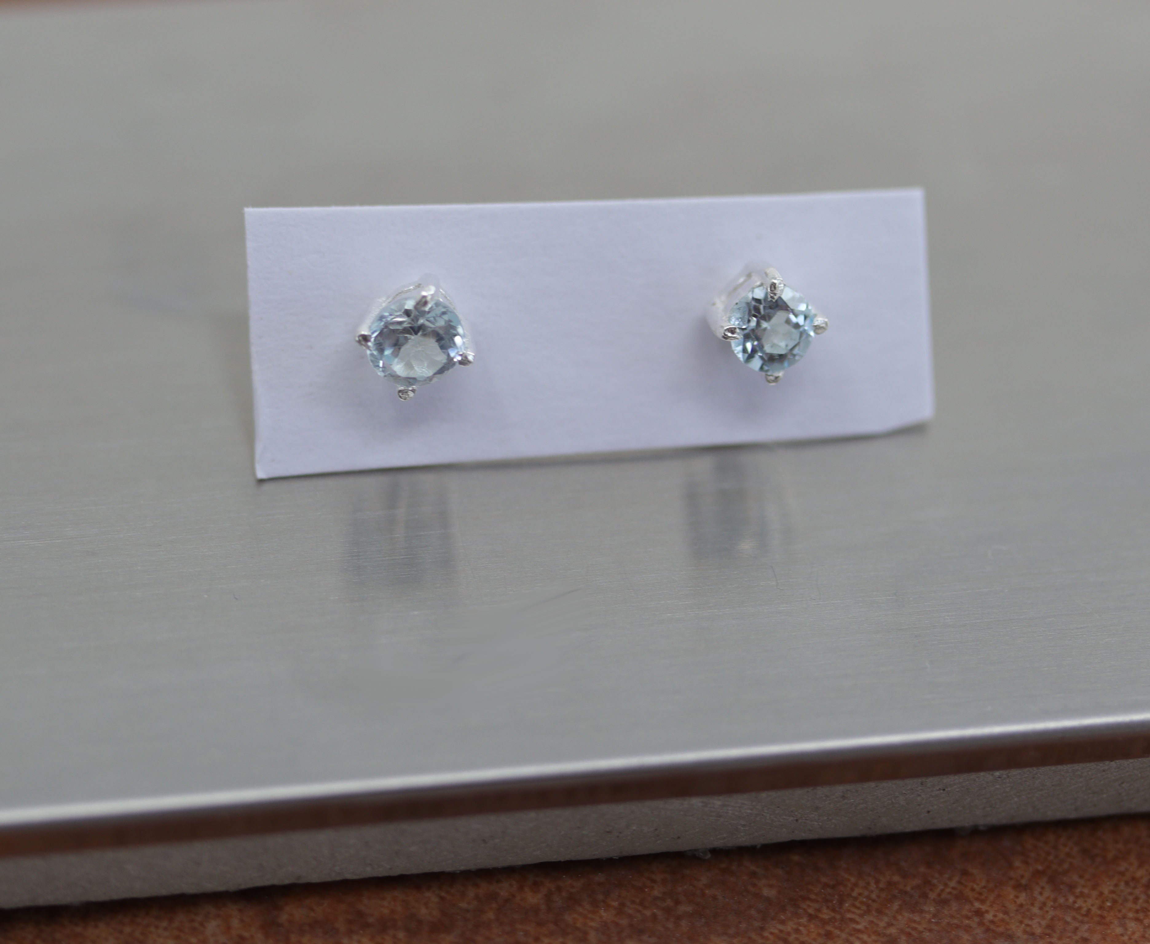 Beautiful gemstone earrings made from sterling silver and genuine aquamarine. The earrings are 3/16" in diameter. 
