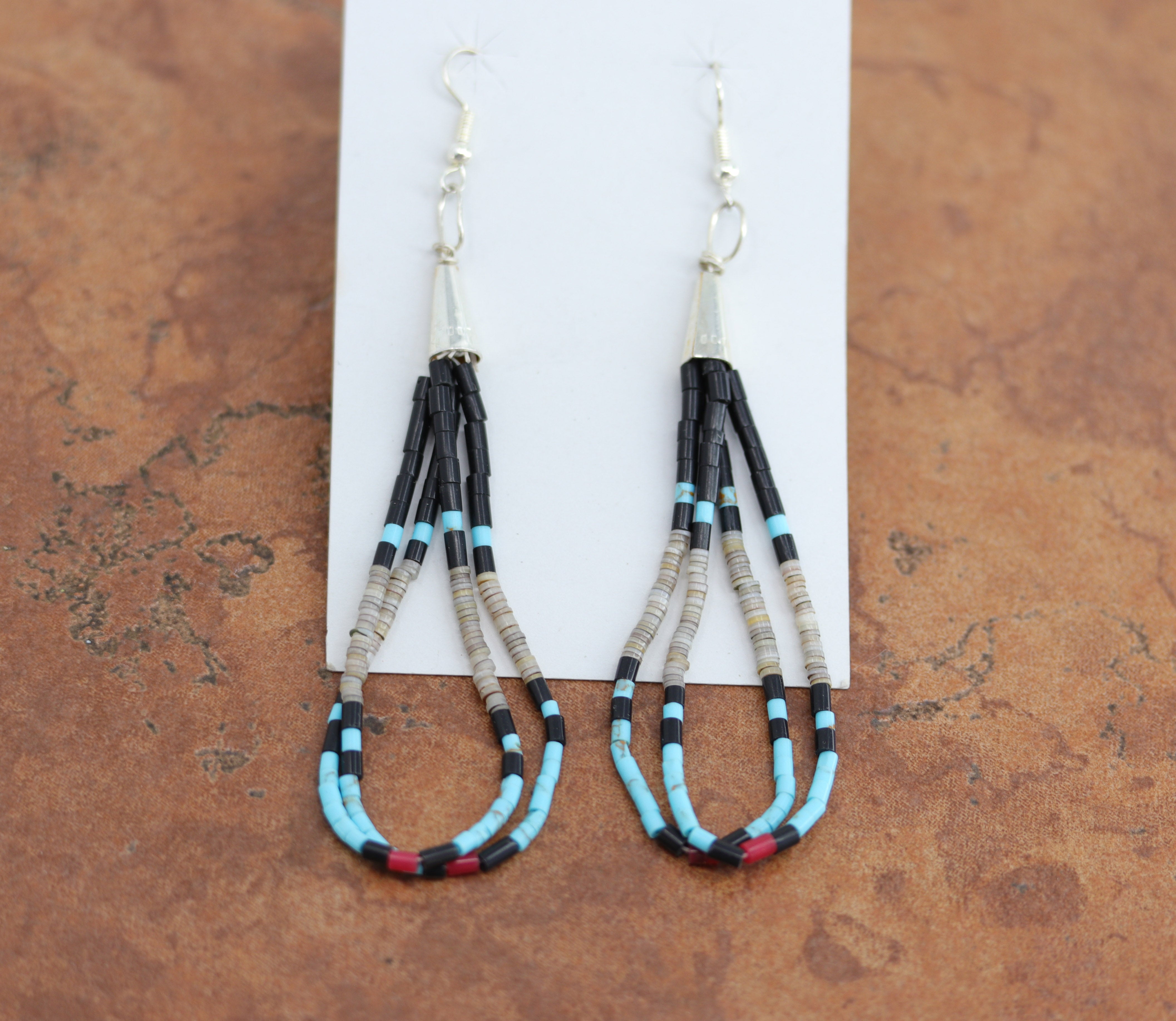 Navajo Native American silver earrings by Paul Tenorio. They are made from sterling silver. The earrings about 3 1/4" long including the hook and 1/8" in width.